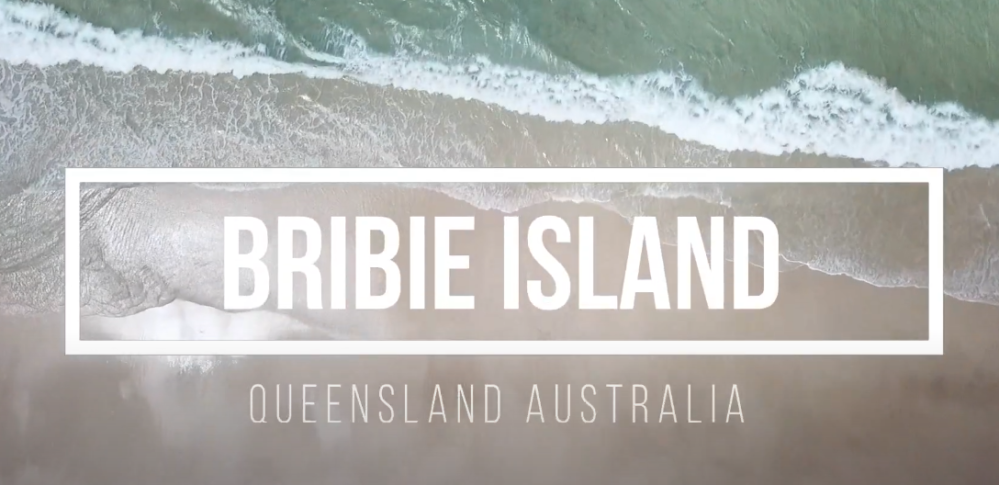 Aerial view of Bribie Island beach with golden sands and clear waters, one of Queensland's best beach destinations.